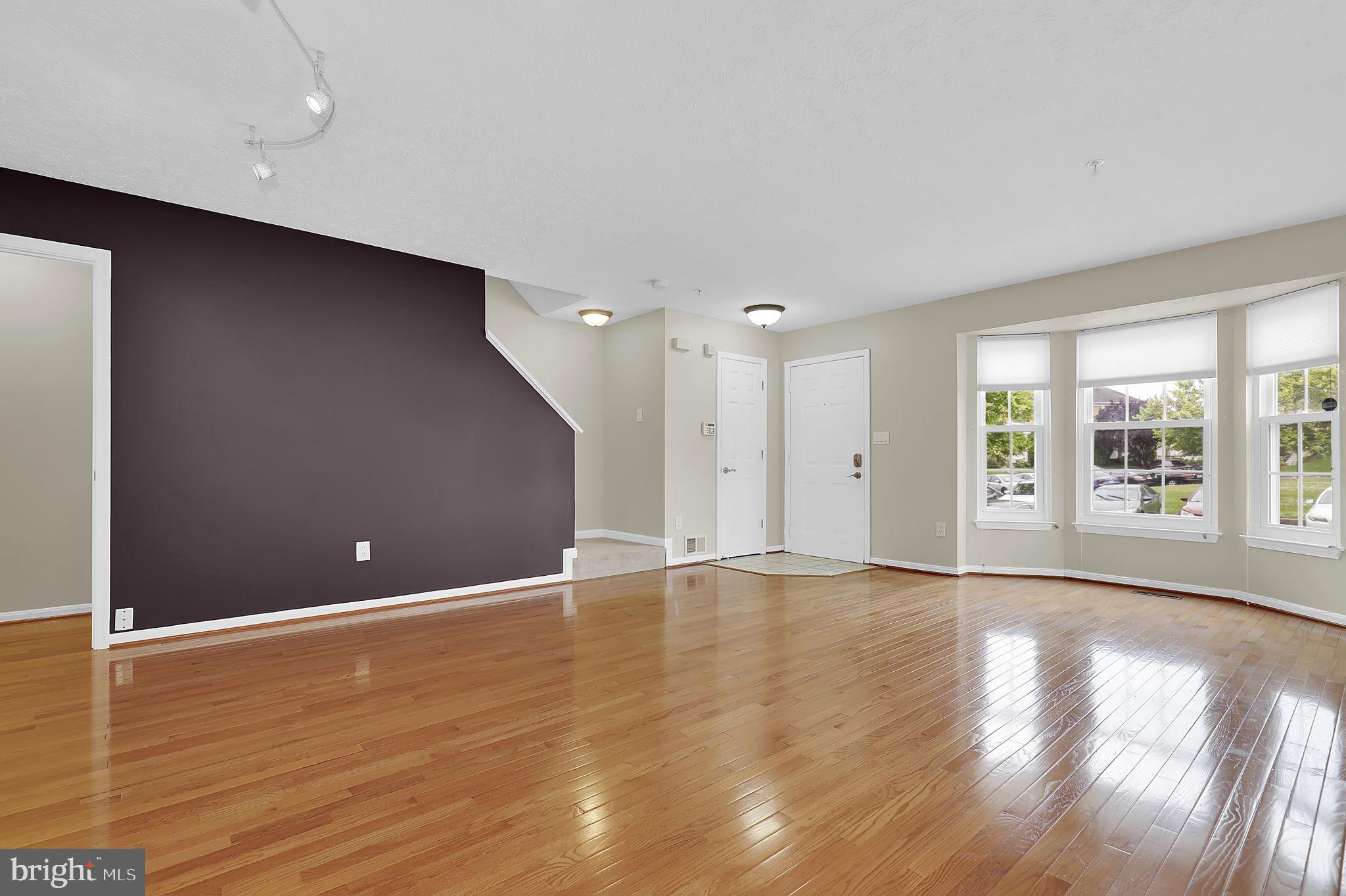 7150 Natures Road Columbia, MD 21046 - Photo 3 of 45 a view of an empty room with wooden floor and a window