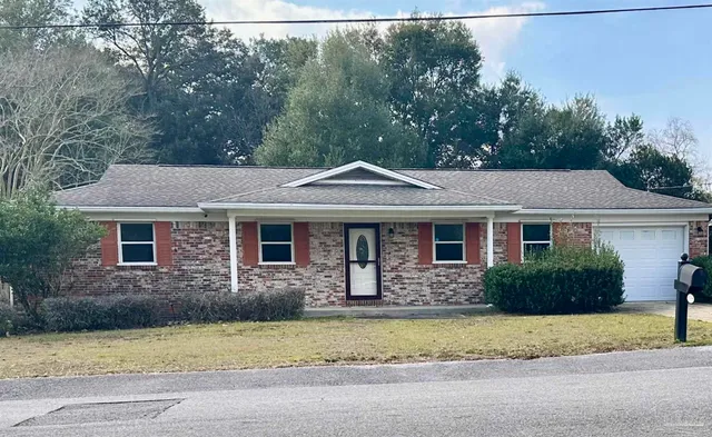 a front view of a house with a garden