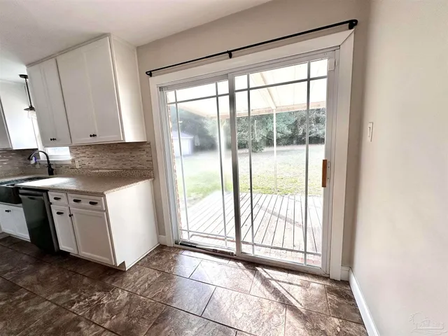 a kitchen with white cabinets and white appliances