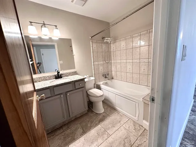 a bathroom with a double vanity sink toilet and shower