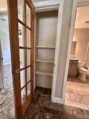 a view of a closet area with an empty room