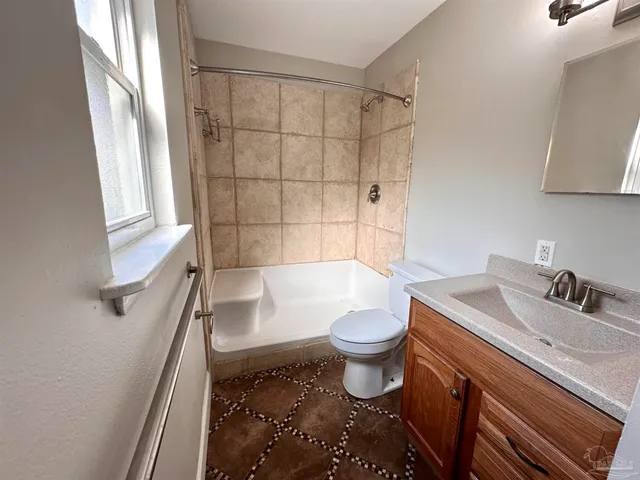 a bathroom with a sink toilet a mirror and shower