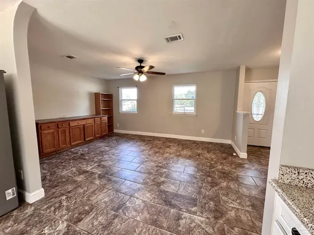 an empty room with windows and entrance