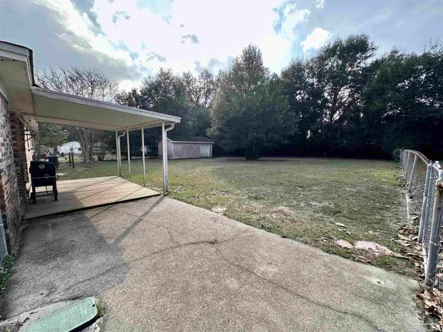 a view of a house with floor to ceiling windows and a basket ball poll