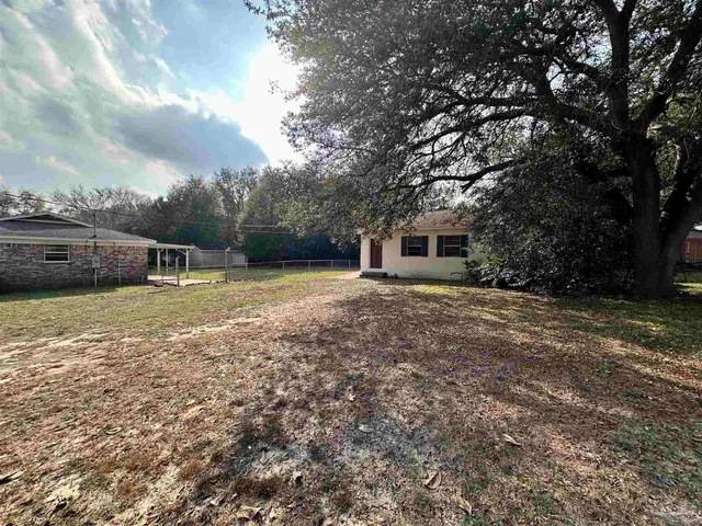 a view of outdoor space with deck and yard