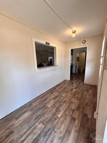 a view of a livingroom with wooden floor and a flat screen tv