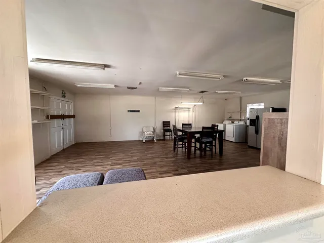 a view of a kitchen and a refrigerator
