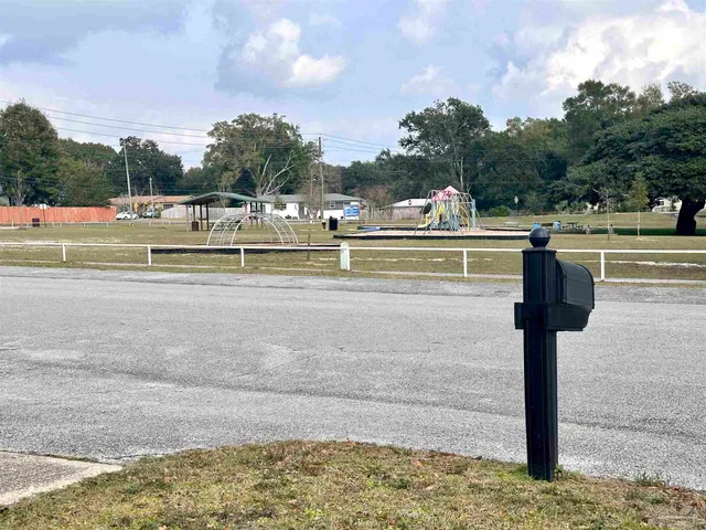 a view of swimming pool with outdoor seating and yard in the back