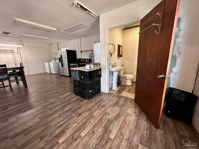 a large bedroom with a bed and a view of living room