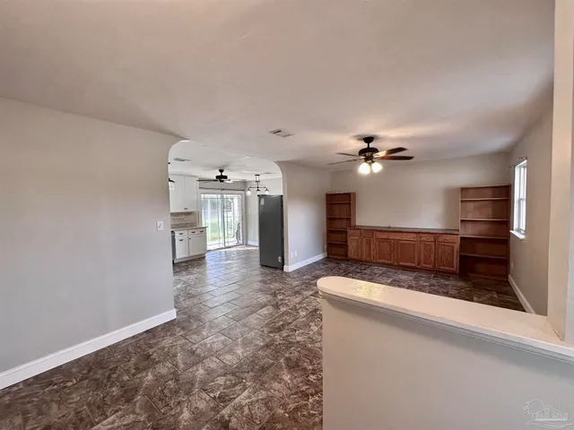 a view of a kitchen with a sink and a refrigerator