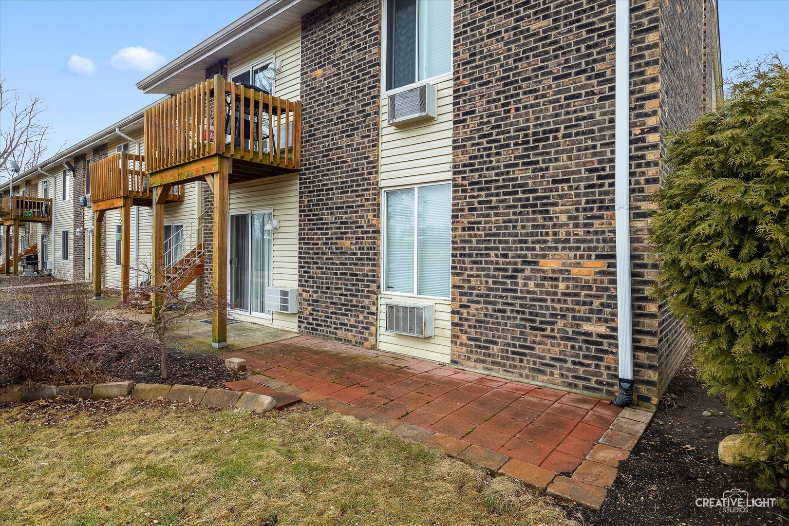 2600 Light Road, Unit 106 Oswego, IL 60543 - Photo 12 of 12 a view of a brick house with many windows