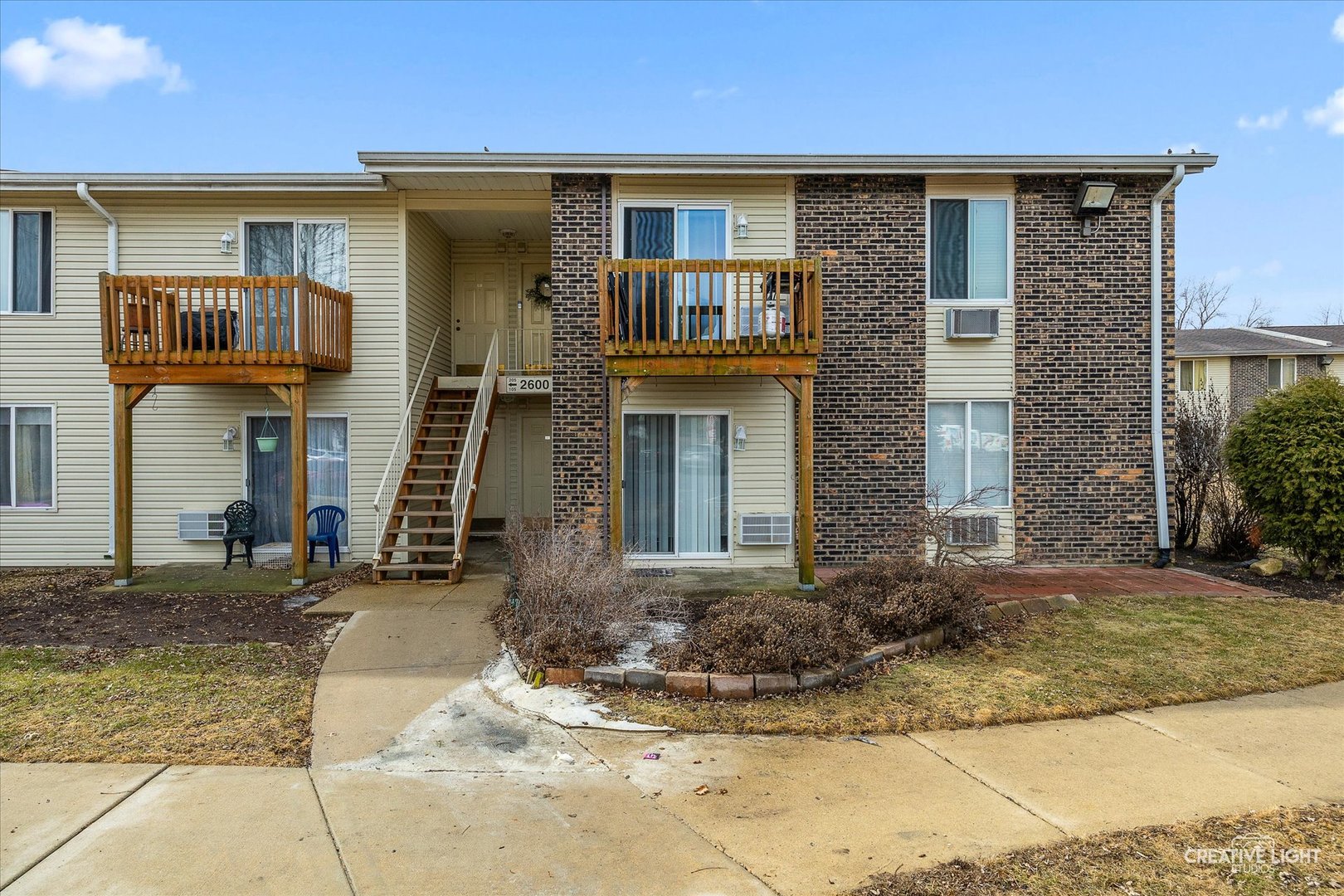 2600 Light Road, Unit 106 Oswego, IL 60543 - Photo 2 of 12 a front view of a house with garden