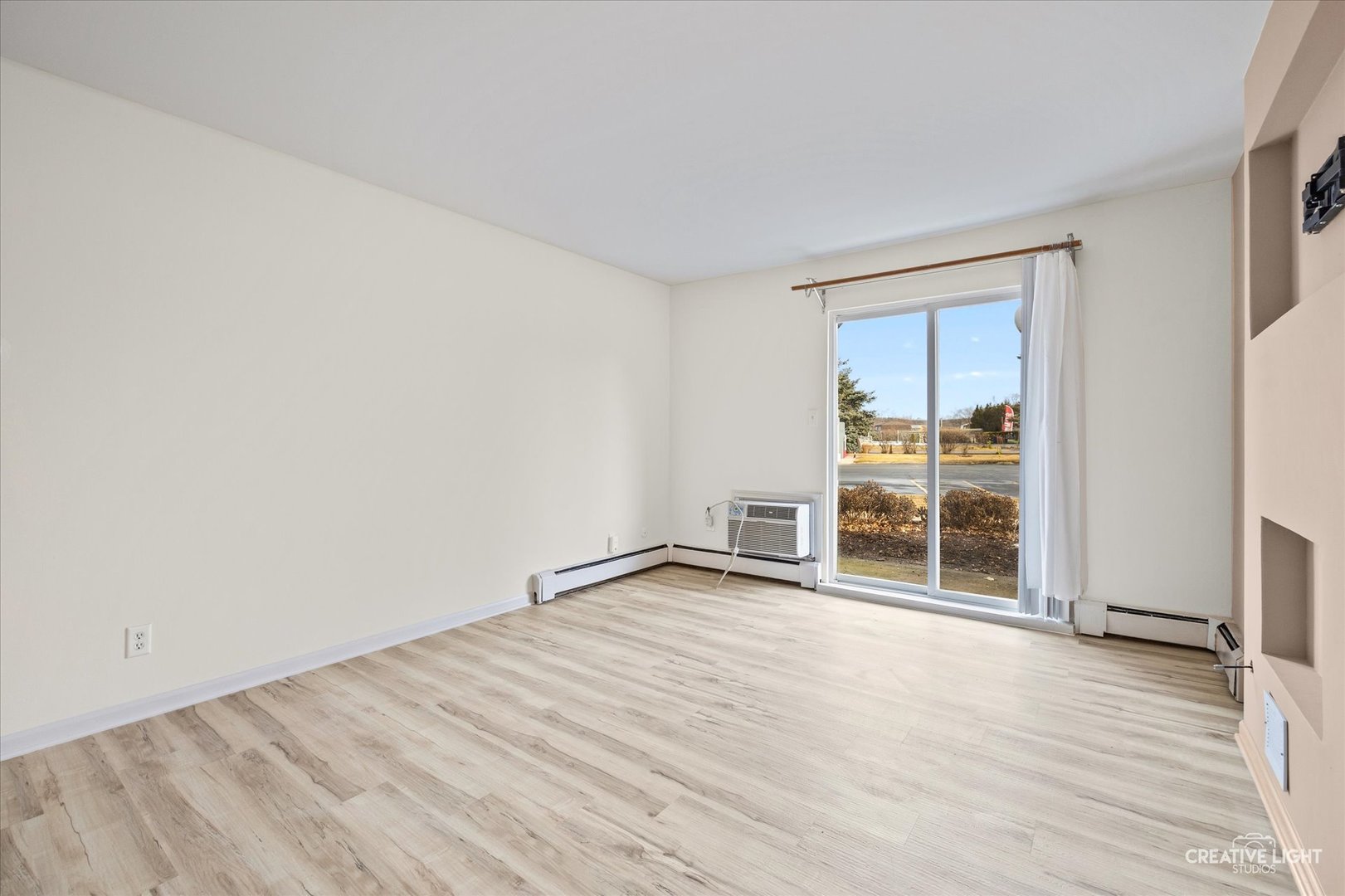 2600 Light Road, Unit 106 Oswego, IL 60543 - Photo 4 of 12 an empty room with wooden floor and windows