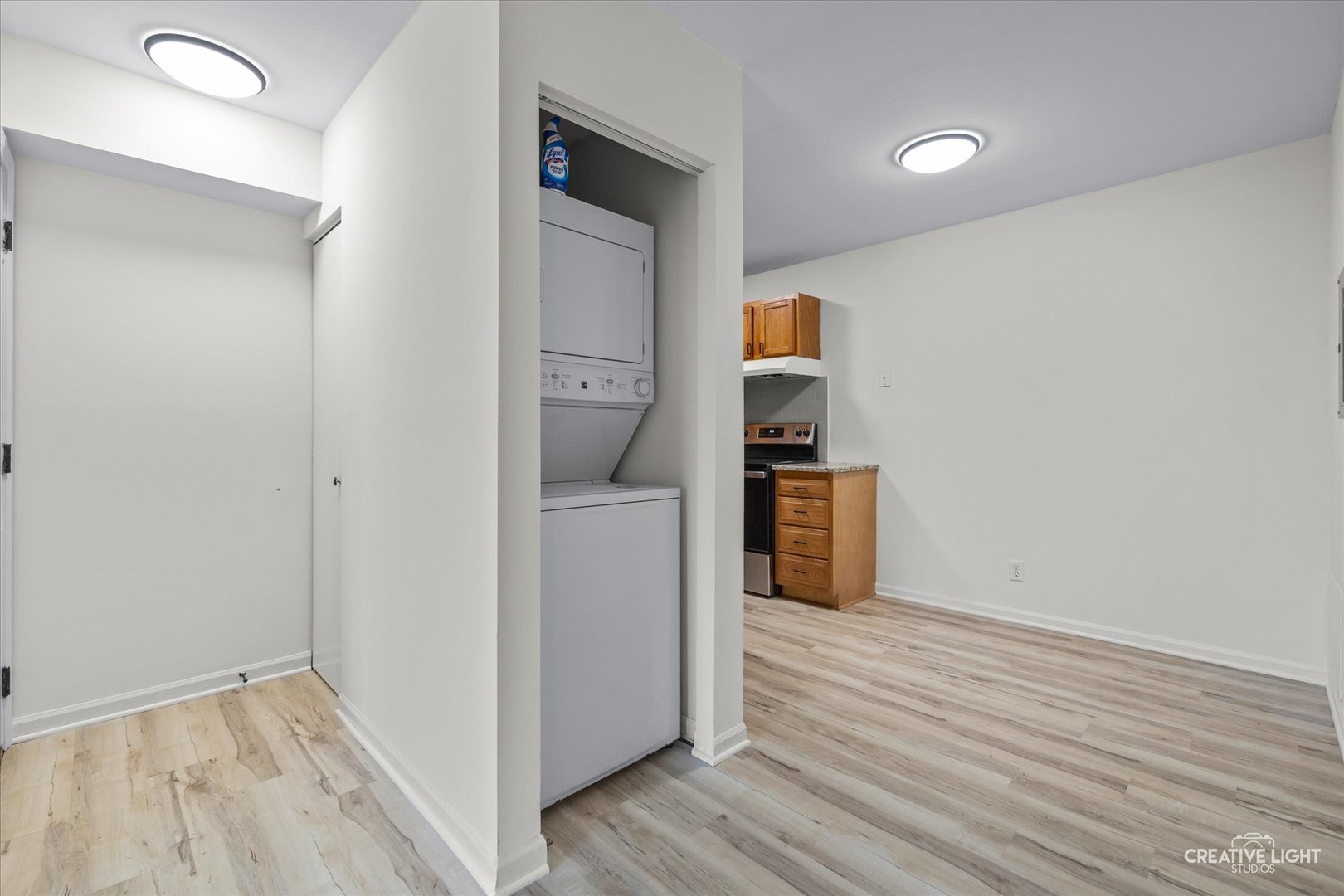 2600 Light Road, Unit 106 Oswego, IL 60543 - Photo 6 of 12 a view of storage and utility room with wooden floor