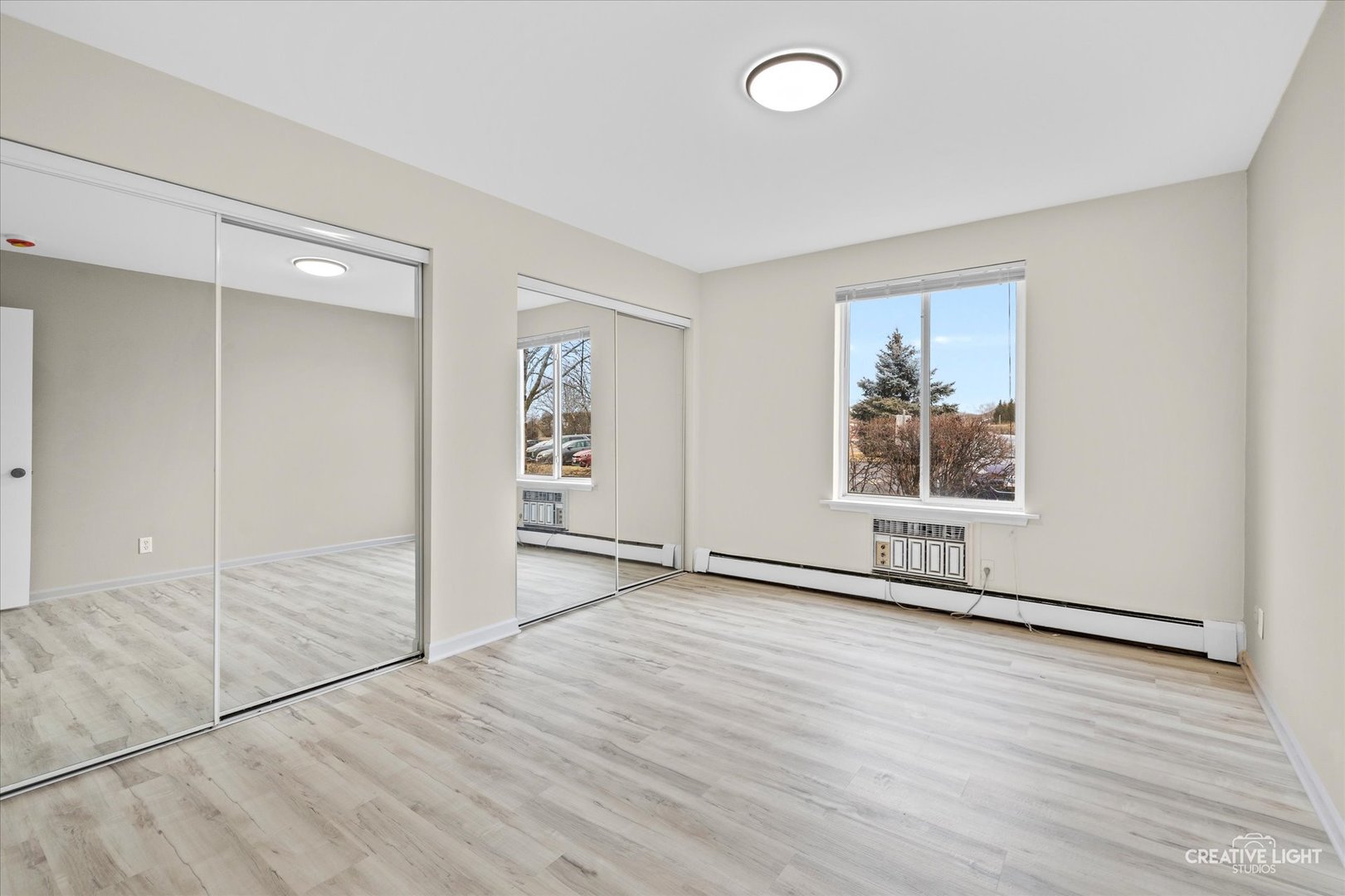 2600 Light Road, Unit 106 Oswego, IL 60543 - Photo 10 of 12 an empty room with wooden floor and windows
