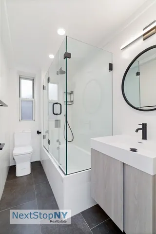 a bathroom with a sink a toilet and a mirror