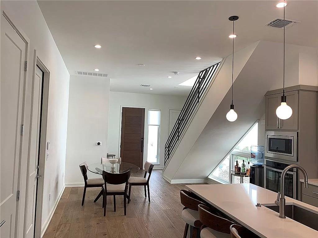 2519 Sutherland Street Austin, TX 78746 - Photo 5 of 14 a dining room with furniture and wooden floor