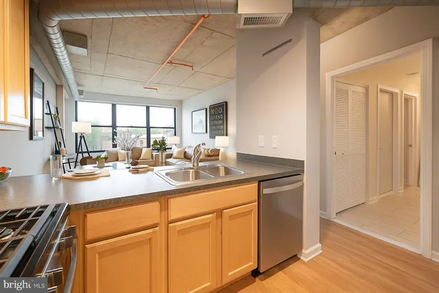 a kitchen with sink cabinets and a wooden floor