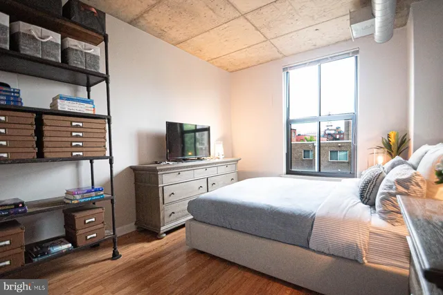 a bedroom with a bed and flat screen tv