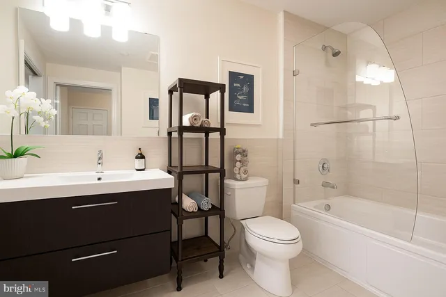 a bathroom with a sink mirror toilet and bathtub