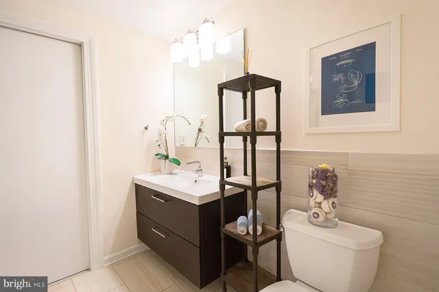 a bathroom with a toilet sink and mirror