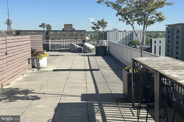 a view of a chairs and a table in the back yard of a house