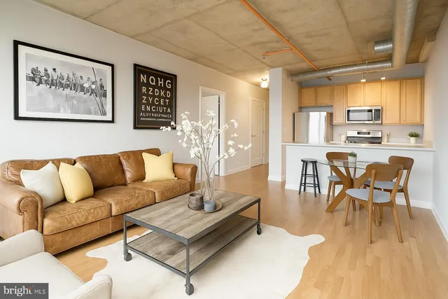 a living room with furniture a wooden floor and a chandelier