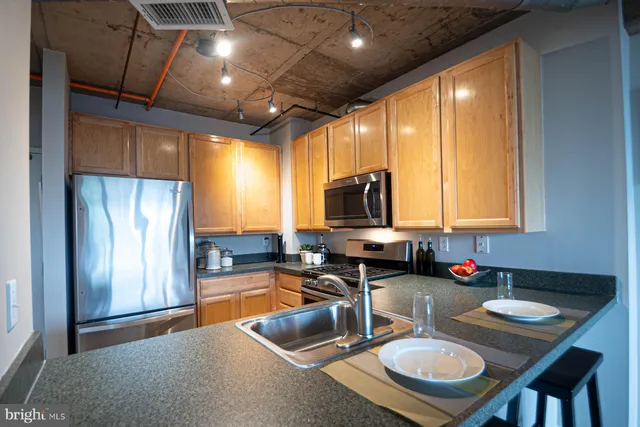 a kitchen with sink refrigerator and window