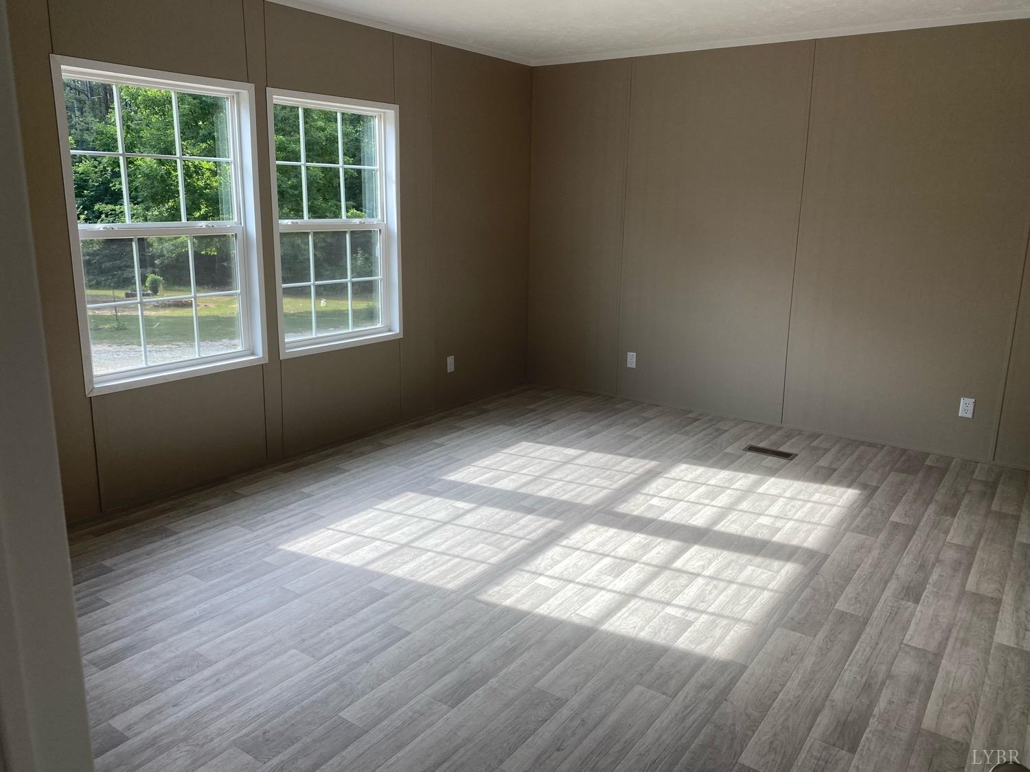 4006 Red House Road Appomattox, VA 24522 - Photo 3 of 11 an empty room with wooden floor and windows