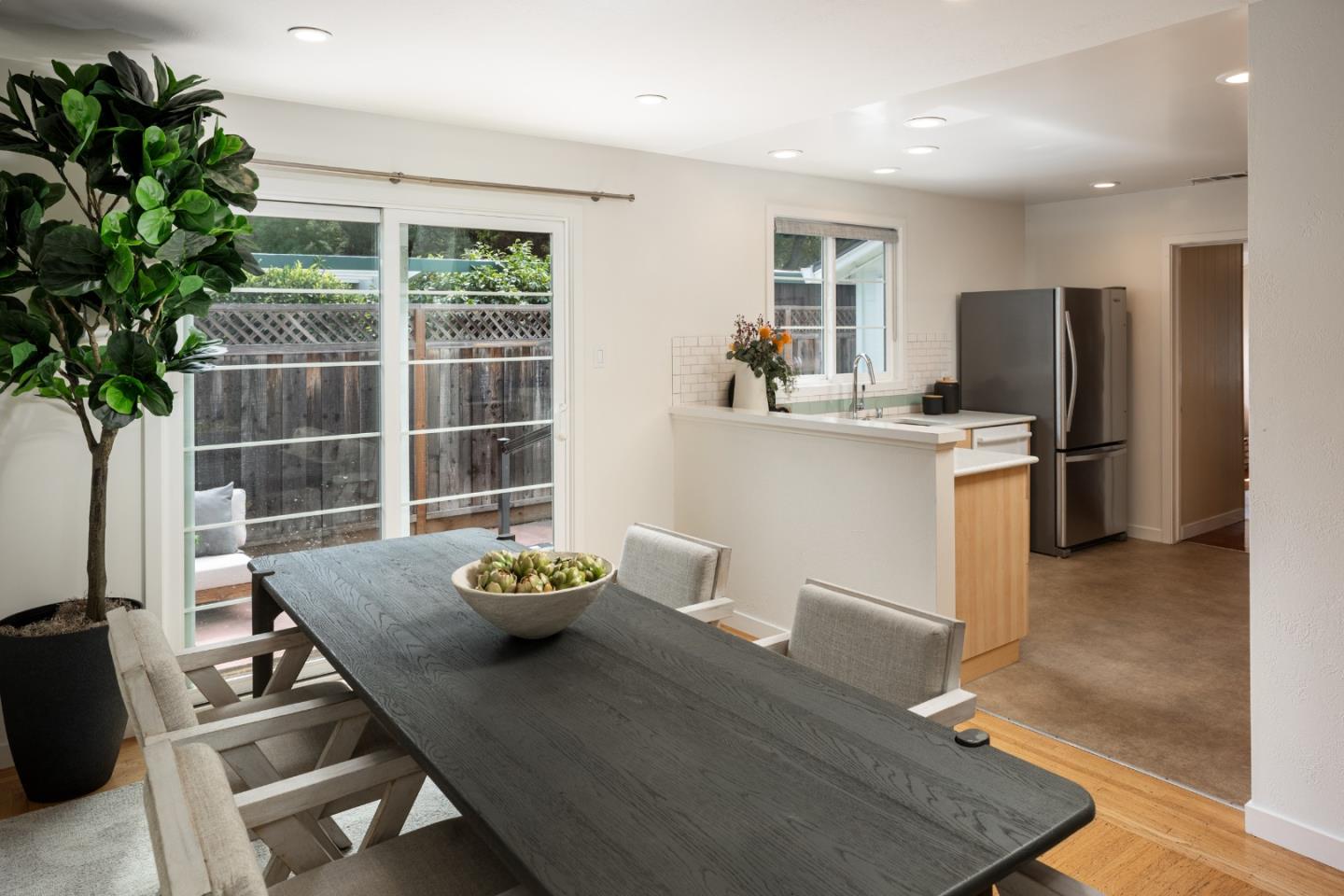 317 Bay Road Menlo Park, CA 94025 - Photo 8 of 26 a living room with stainless steel appliances kitchen island furniture and a potted plant