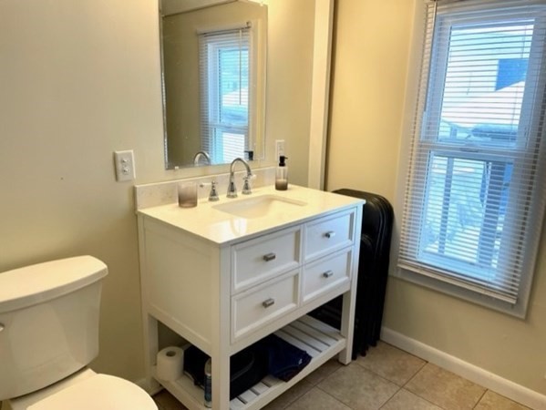 1 B Kittredge Road Shirley, MA 01464 - Photo 11 of 16 a spacious bathroom with a double vanity sink a mirror and a toilet