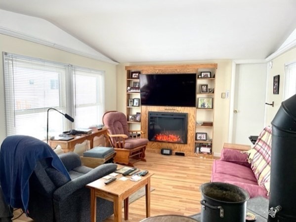 1 B Kittredge Road Shirley, MA 01464 - Photo 5 of 16 a living room with furniture a flat screen tv and a fireplace