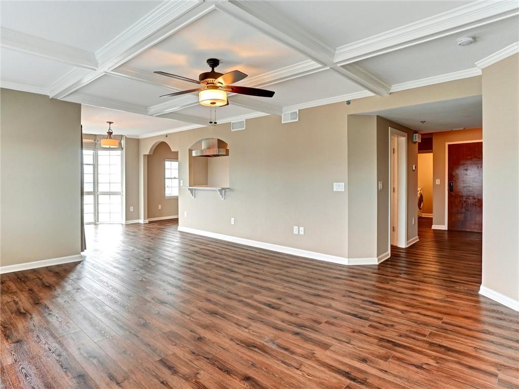 3435 Kingsboro Road Northeast, Unit 1601 Atlanta, GA 30326 - Photo 16 of 54 a view of an empty room with window and wooden floor