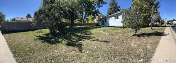 a backyard of a house with a yard and outdoor seating