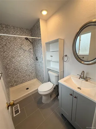a bathroom with a sink a toilet and a mirror