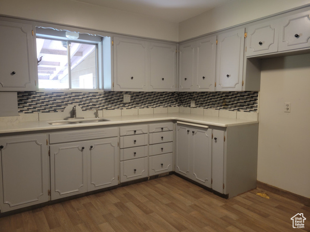 360 West 200 North Logan, UT 84321 - Photo 3 of 26 Kitchen featuring decorative backsplash, light countertops, and dark wood-type flooring