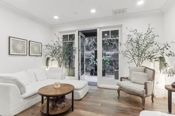 a living room with furniture and a potted plant