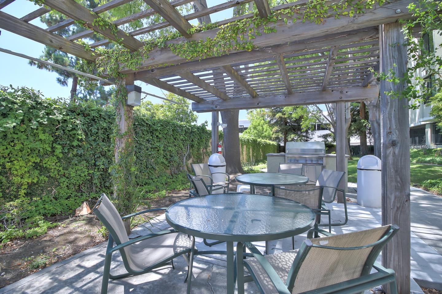 2200 Agnew Road, Unit 210 Santa Clara, CA 95054 - Photo 18 of 30 a view of a patio with a table chairs and a backyard