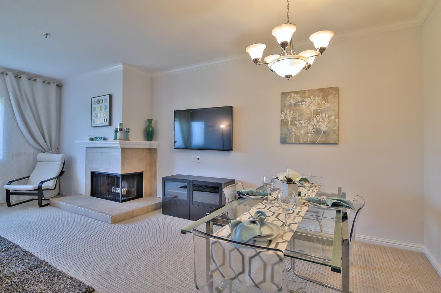 2200 Agnew Road, Unit 210 Santa Clara, CA 95054 - Photo 3 of 30 a living room with furniture a fireplace and a chandelier