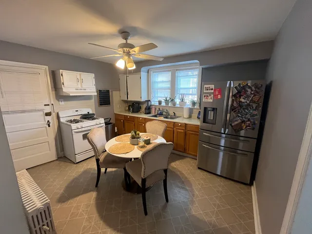 a kitchen with stainless steel appliances kitchen island granite countertop furniture and a refrigerator