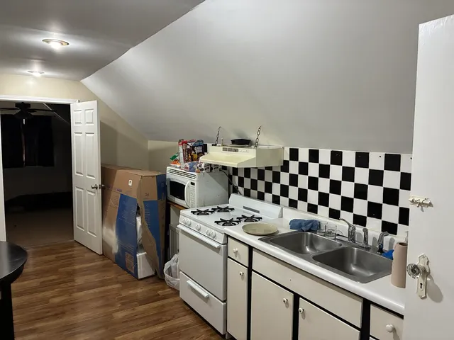 a kitchen with granite countertop a sink and cabinets