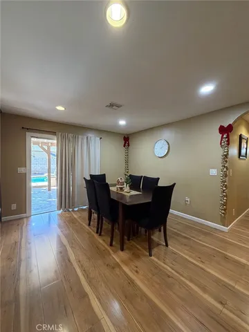 a view of a dining room with furniture and wooden floor