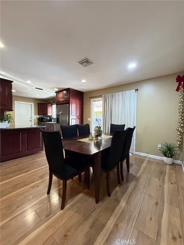 a view of a dining room with furniture and wooden floor