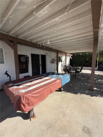 a swimming pool with outdoor seating and yard