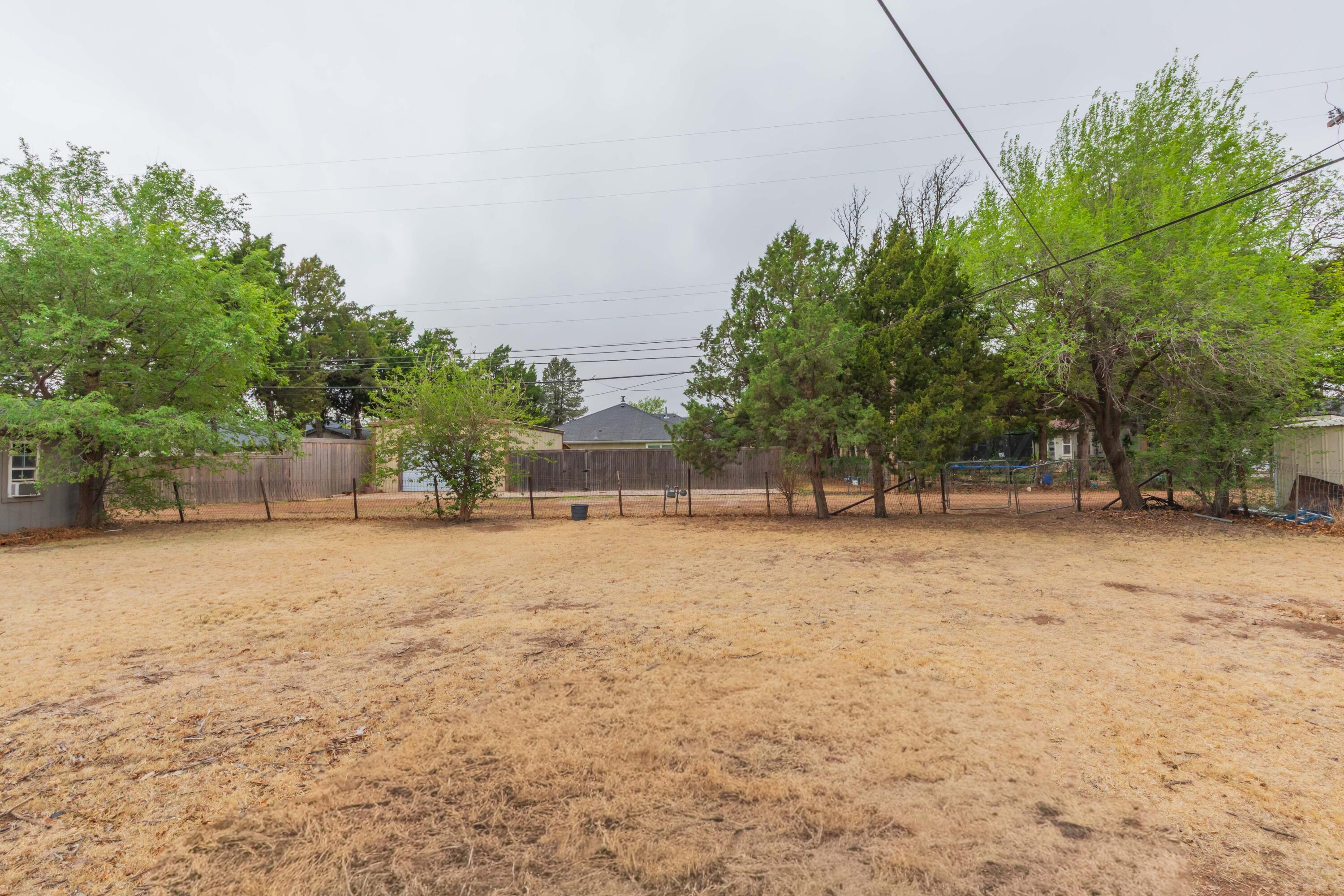 504 High Street Claude, TX 79019 - Photo 37 of 39 a backyard of a house with a trees