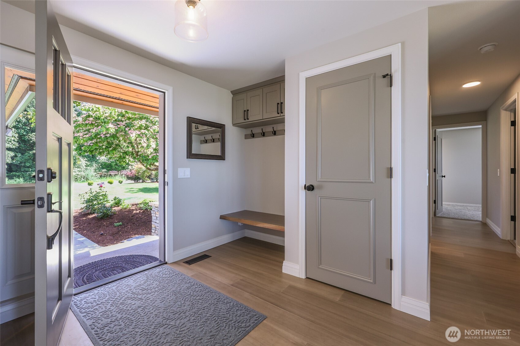 7713 78th Loop Northwest Olympia, WA 98502 - Photo 29 of 40 a view of a hallway with wooden floor and a bedroom