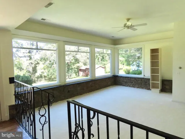 a front view of house with a garden and deck