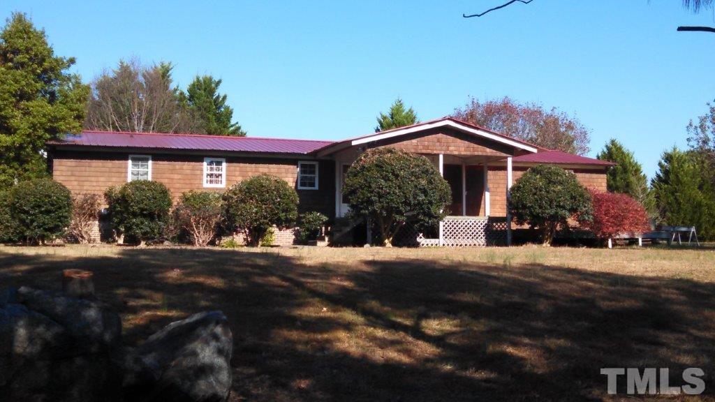 2001 Sanders Road Stem, NC 27581 - Photo 1 of 21 a front view of a house with a yard