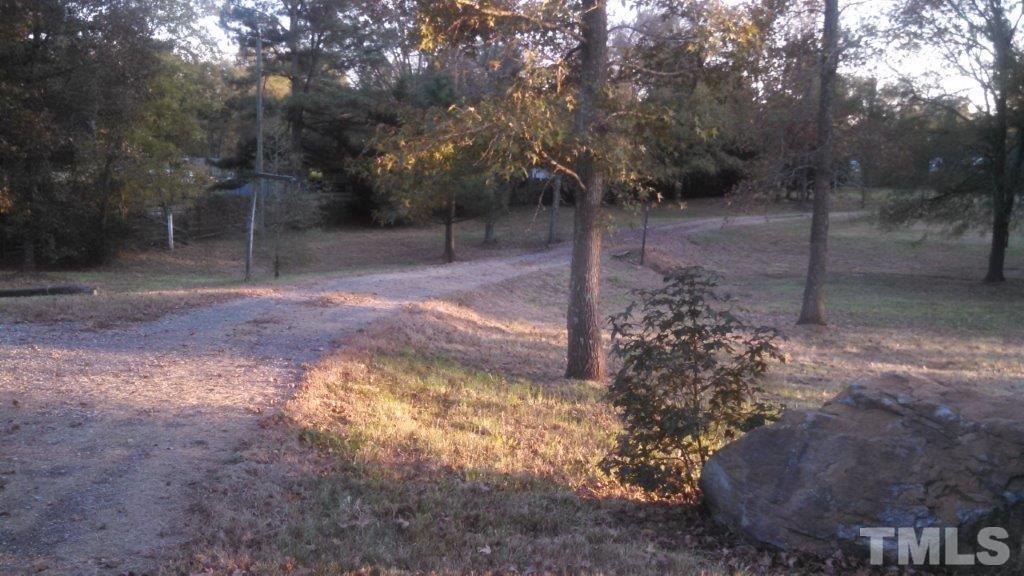 2001 Sanders Road Stem, NC 27581 - Photo 2 of 21 a view of a yard with trees