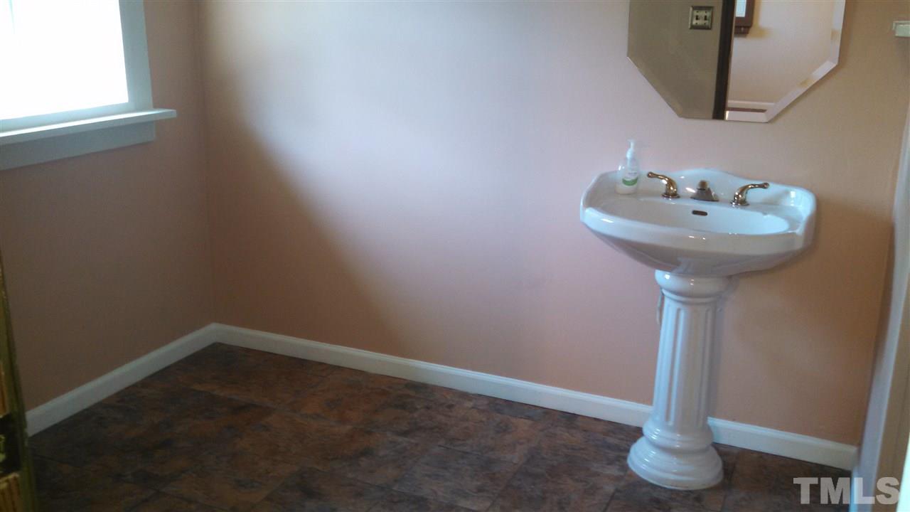 2001 Sanders Road Stem, NC 27581 - Photo 13 of 21 a bathroom with a sink and a window